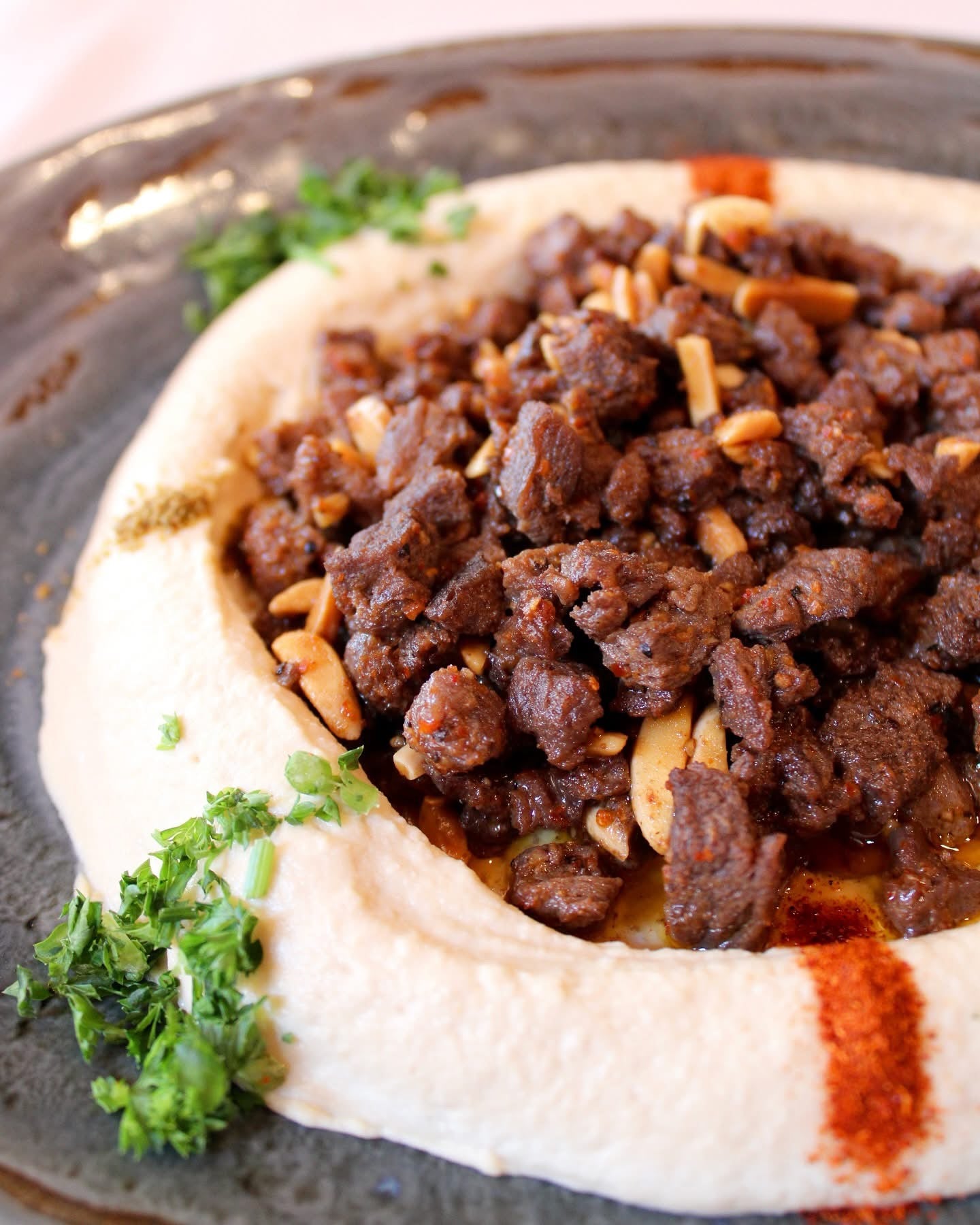 Hummus topped with meat